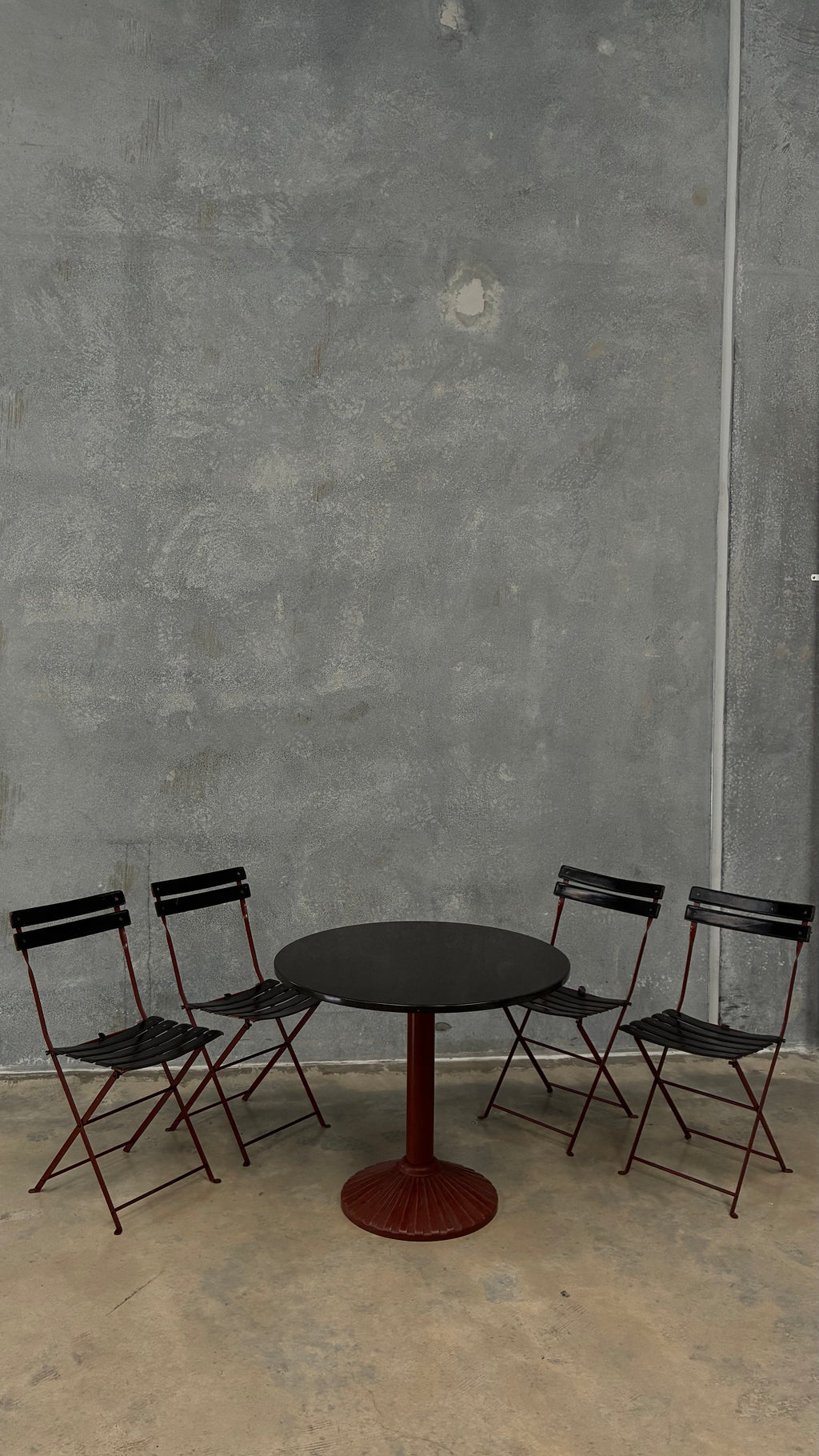 Set of four Zanotta folding chairs, Italy 1980s, presented with a customer grante dining table