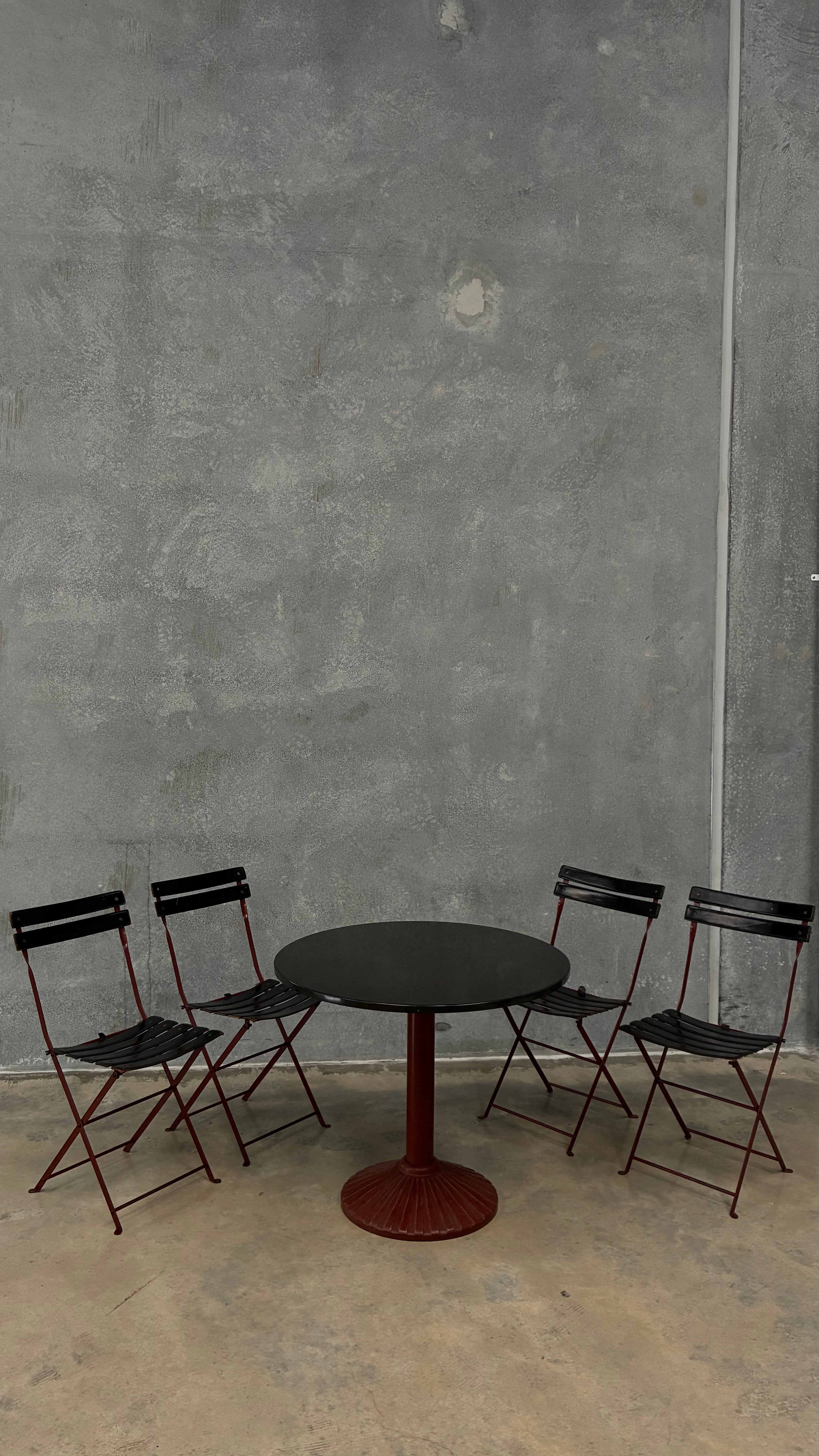 Set of four Zanotta folding chairs, Italy 1980s, presented with a customer grante dining table
