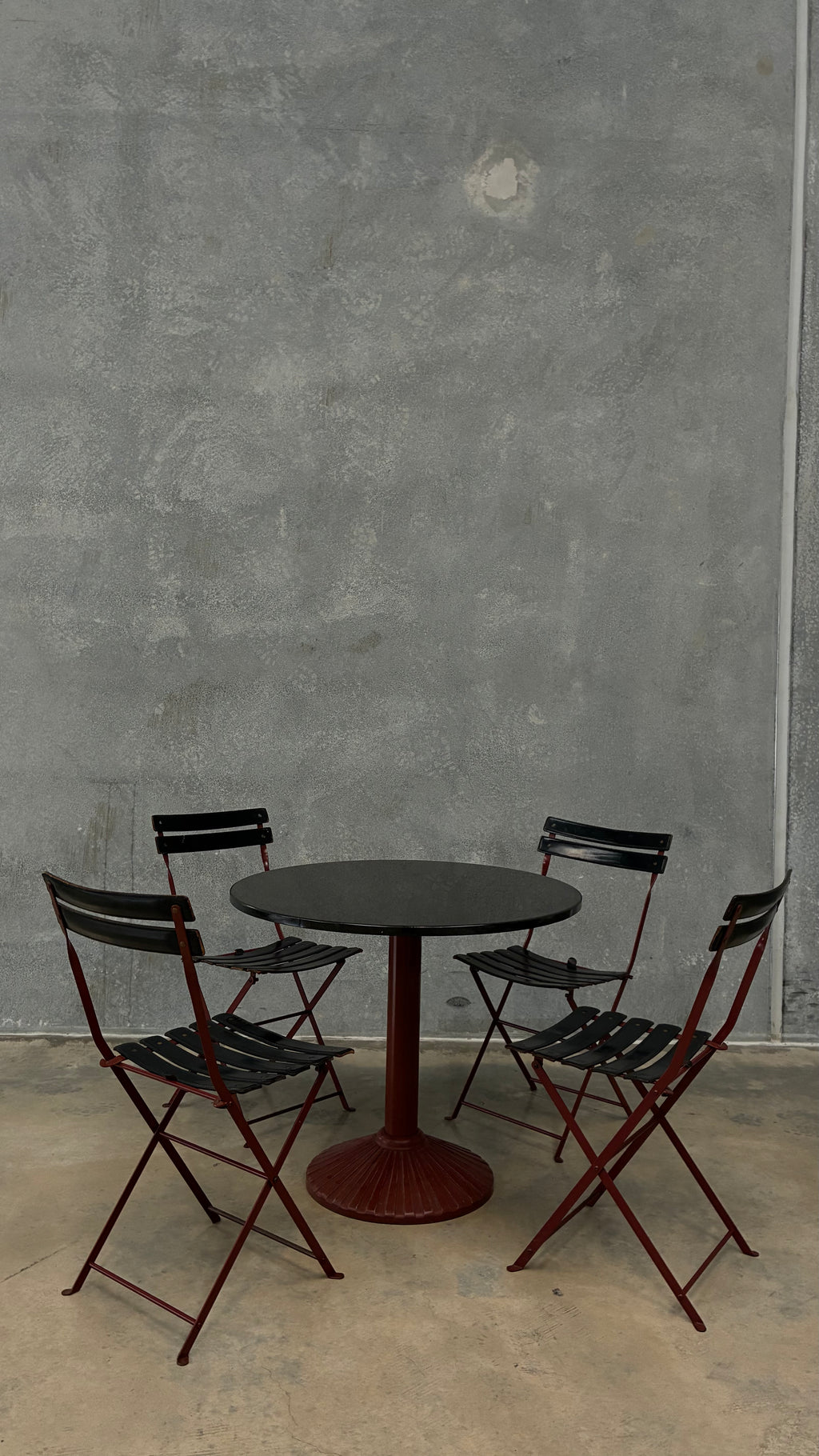 Set of four Zanotta folding chairs, Italy 1980s, presented with a customer grante dining table