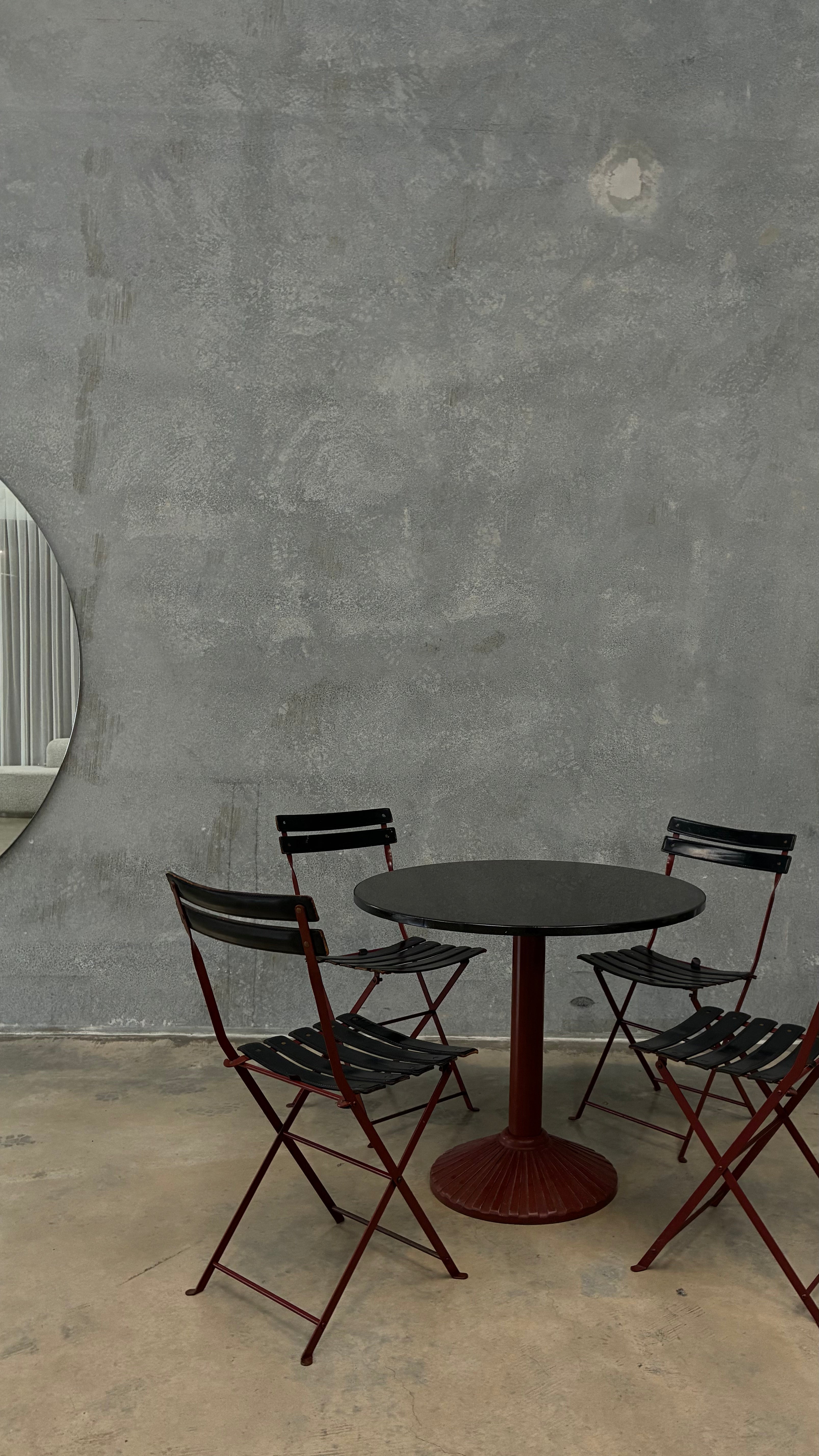 Set of four Zanotta folding chairs, Italy 1980s, presented with a customer grante dining table