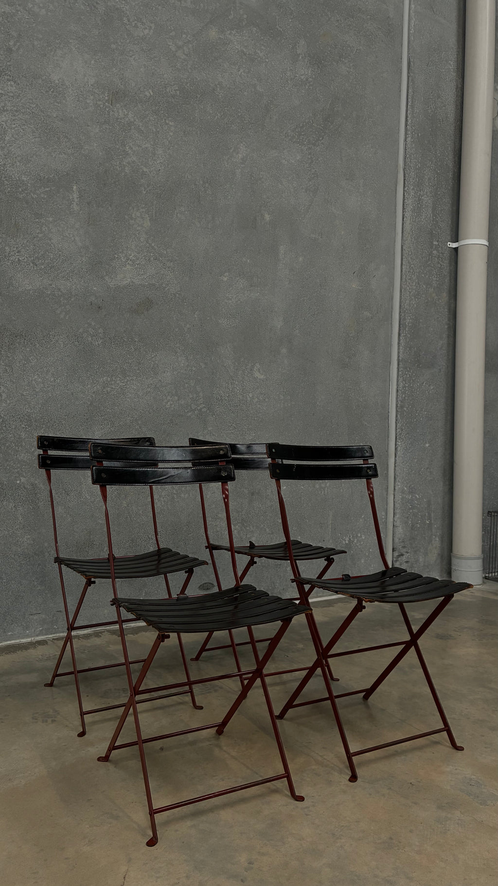 Set of four Zanotta folding chairs, Italy 1980s, presented with a customer grante dining table