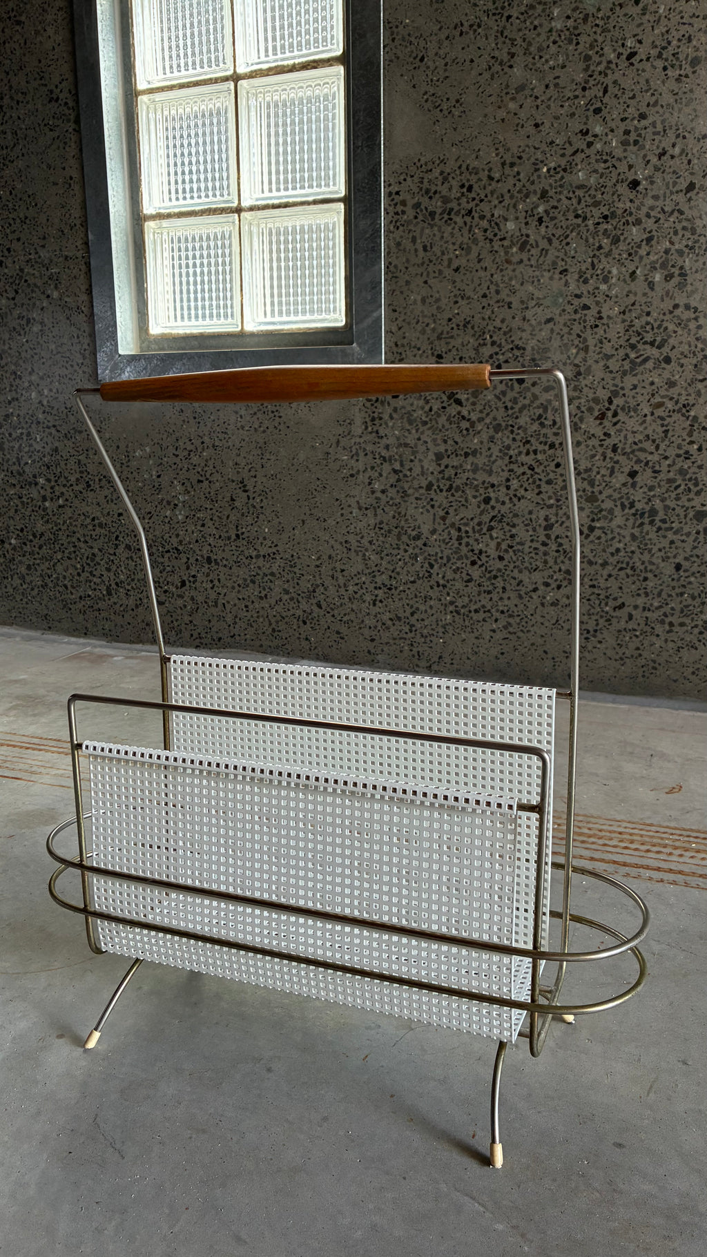 Mid-Century Magazine rack in the style of Mathieu Matégot