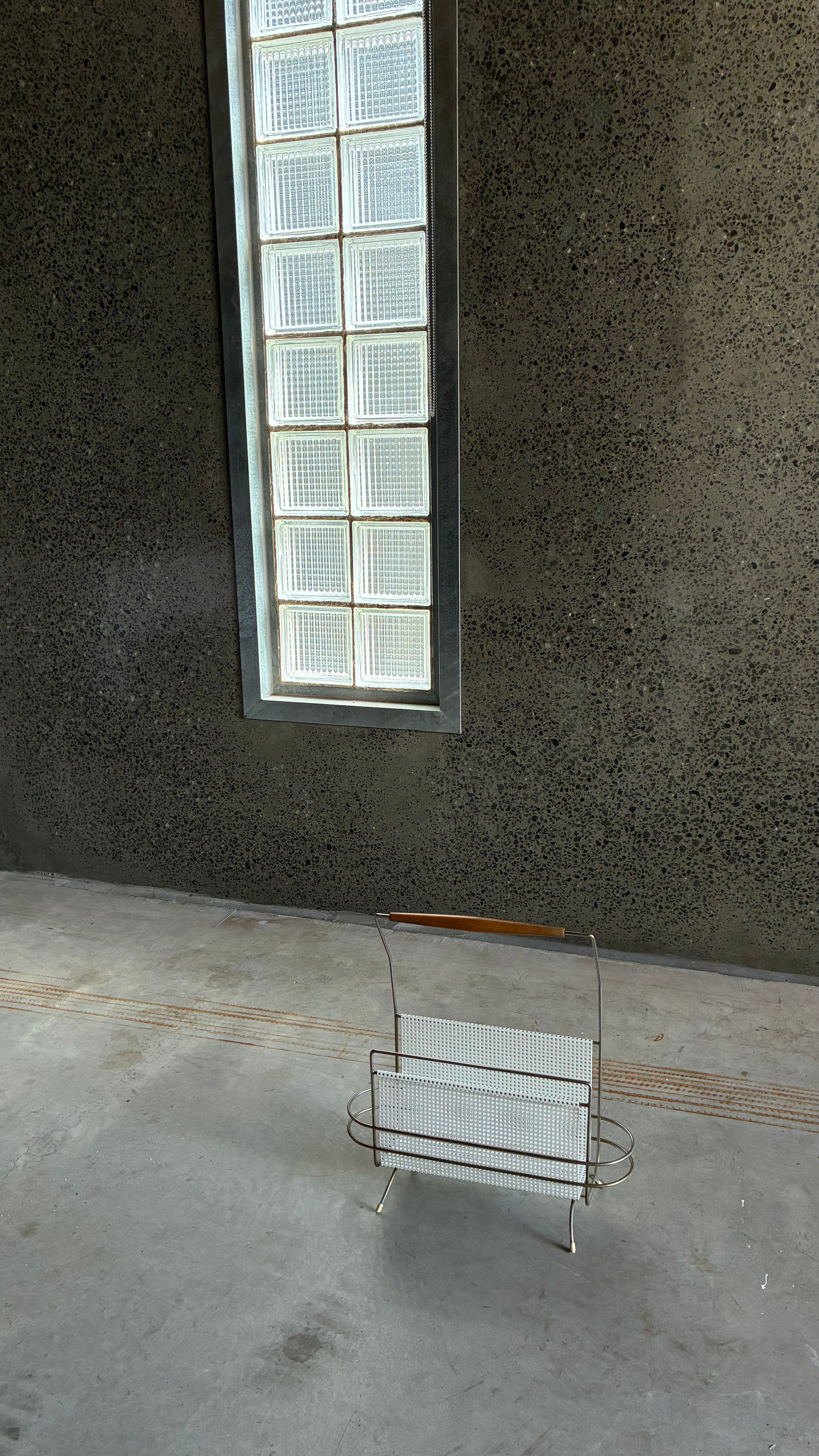 Mid-Century Magazine rack in the style of Mathieu Matégot