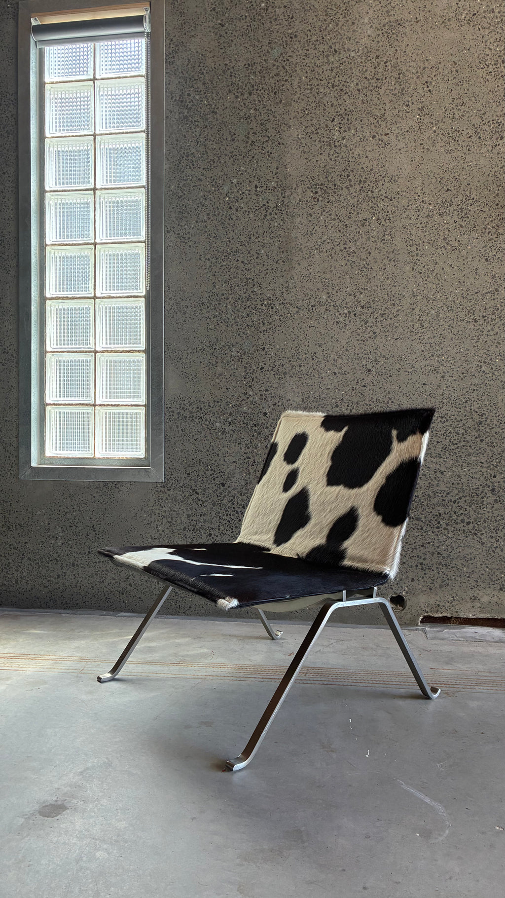 COWHIDE AND BRUSHED STEEL LOUNGE CHAIR