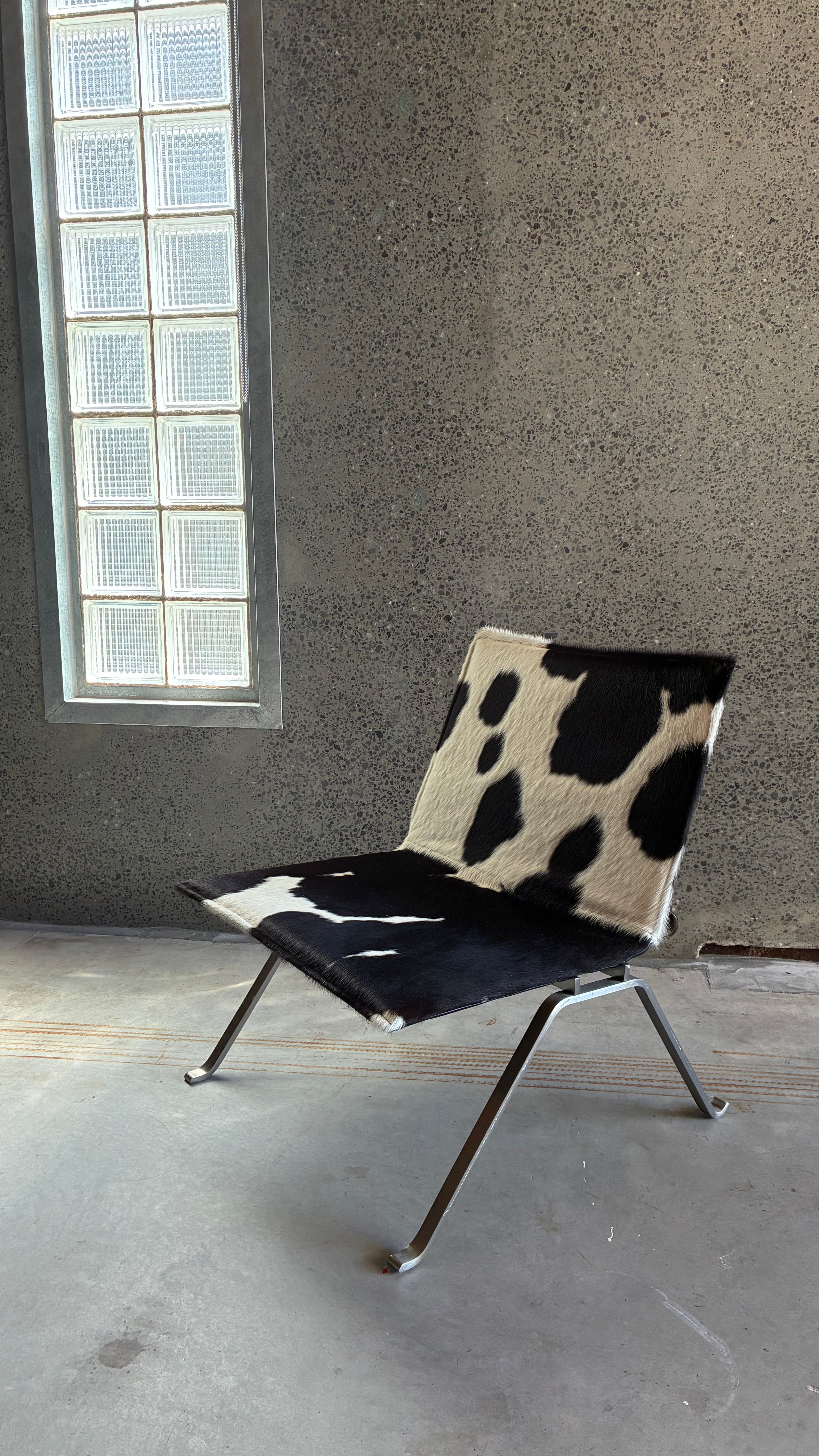 COWHIDE AND BRUSHED STEEL LOUNGE CHAIR