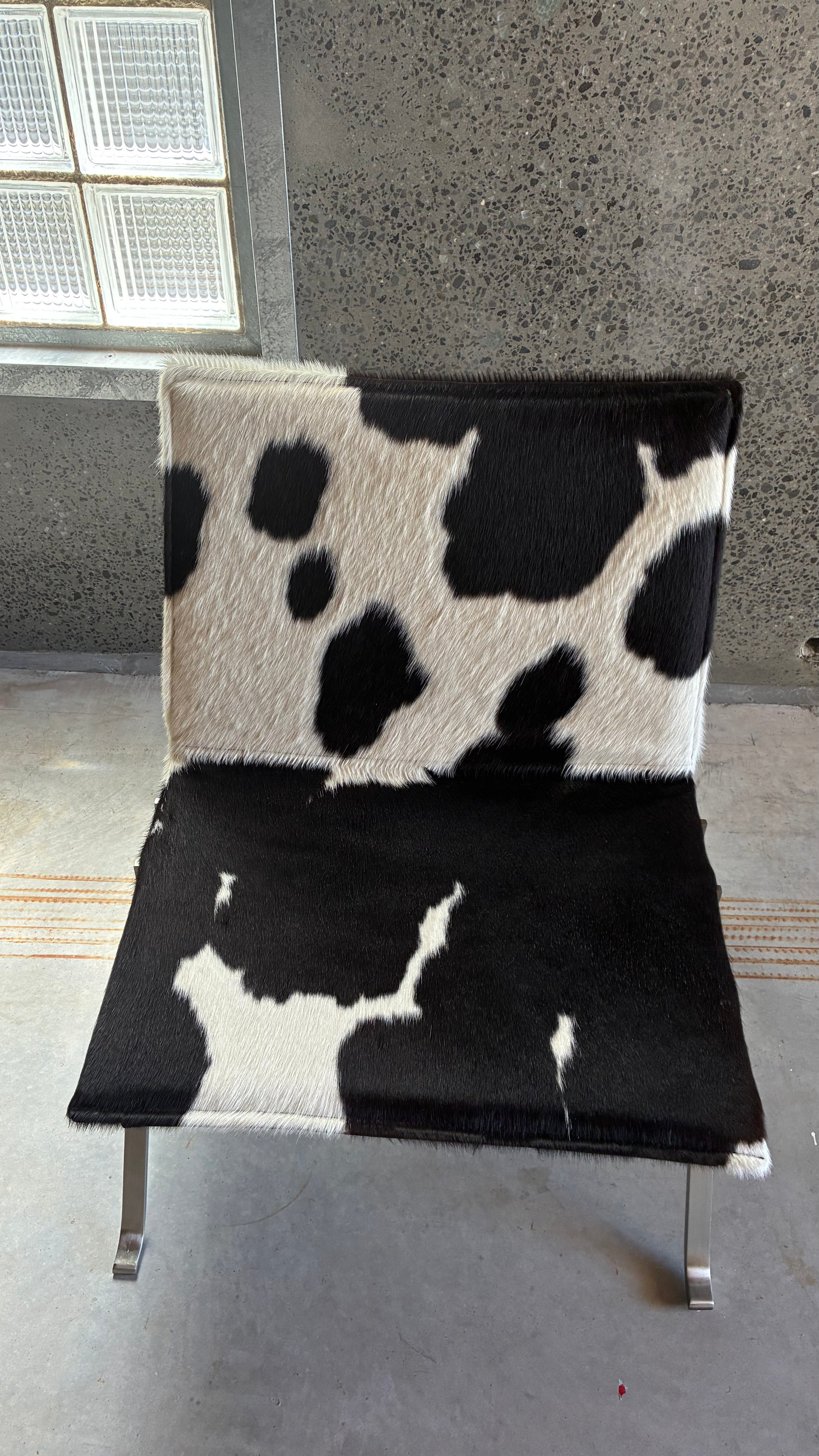 COWHIDE AND BRUSHED STEEL LOUNGE CHAIR