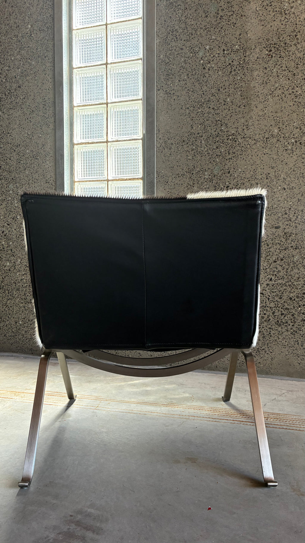 COWHIDE AND BRUSHED STEEL LOUNGE CHAIR