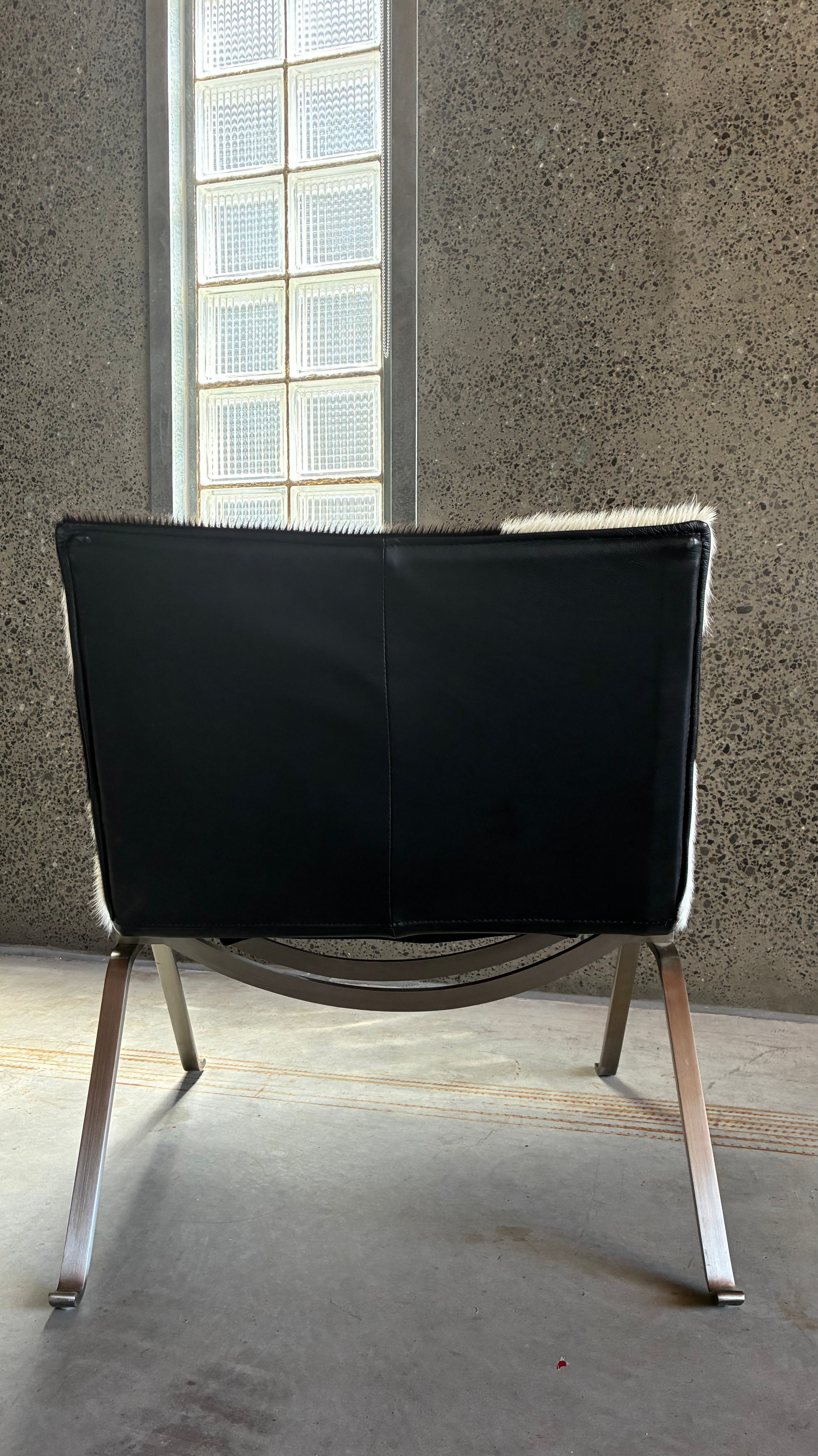 COWHIDE AND BRUSHED STEEL LOUNGE CHAIR